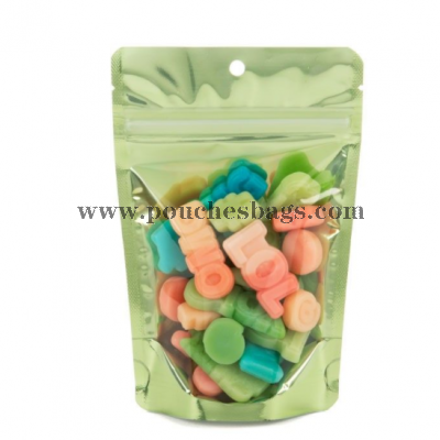 Packaged candy inside green stand up pouch w/ hang hole